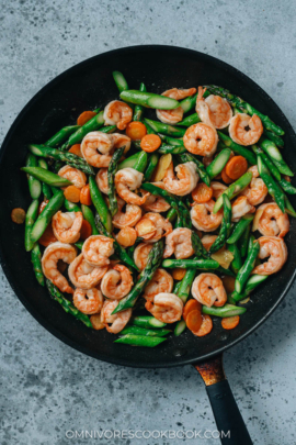 Shrimp and asparagus stir fry in a pan