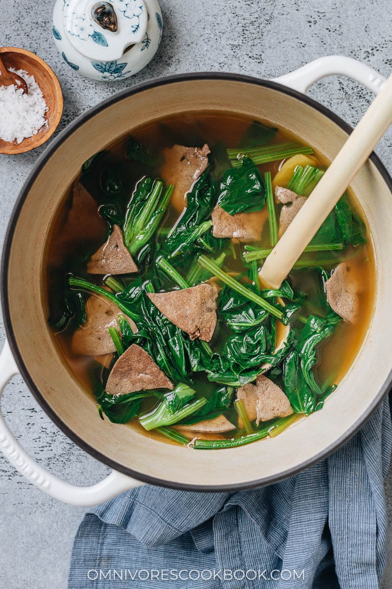 Pork liver soup with spinach in a pot