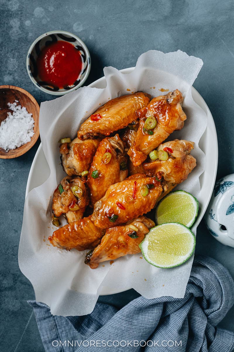Crispy air fryer wings coated with sweet chili sauce with lime on the side