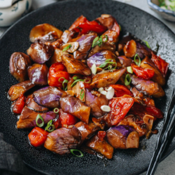 Eggplant with tomato stir fry is a delightful summer dish that is perfect for a side and satisfying as a main. The eggplant is slightly charred, cooked with tender tomato in an aromatic savory brown sauce. It’s very easy to put together for your weekday dinner! {Vegetarian Adaptable, Gluten-Free Adaptable}