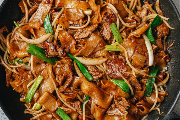 Homemade beef chow fun in a pan