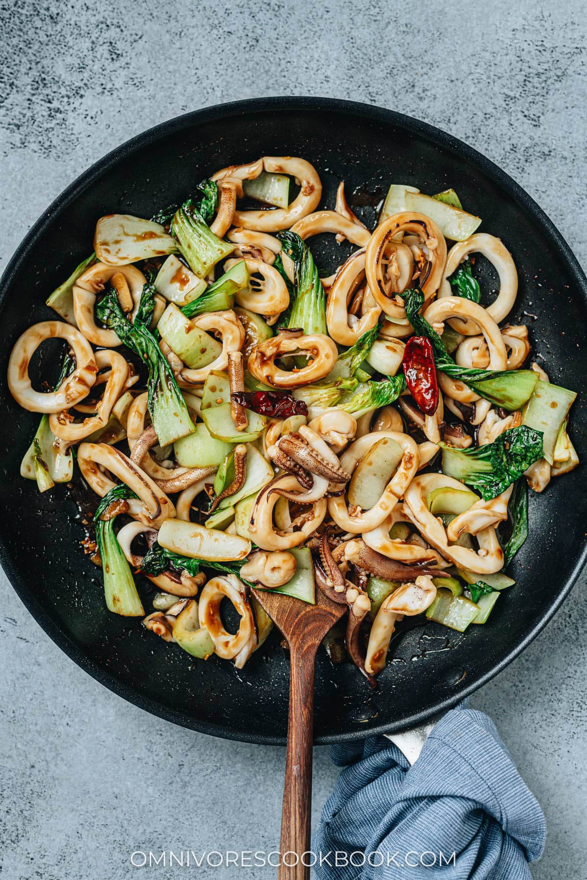 Squid and bok choy stir fry in a pan