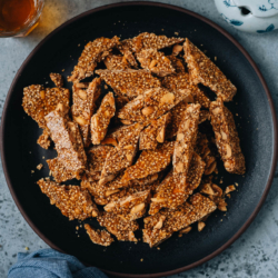 Crunchy, sweet and nutty, peanut sesame brittle is a delicious treat that can easily be made at home. Make this crowd favorite snack for holiday gifting or to serve at festivals such as Chinese New Year. {Vegetarian, Gluten-Free}