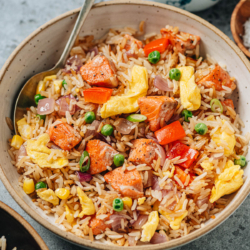 Salmon fried rice is a delicious one-pan meal that you can quickly whip together using a few pantry ingredients. The juicy salmon, tender eggs, crisp veggies and buttery rice all work together to create a satisfying and healthy meal for your weekday dinner. {Gluten-Free Adaptable}