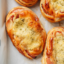 Make Chinese bakery-style ham and cheese buns that have a soft and moist bread dough, crispy ham, and melty cheese topping. This recipe includes a very easy foolproof milk bread recipe that requires little hands-on time. Make these ahead of time for breakfast, snacks, or a treat at your holiday party.