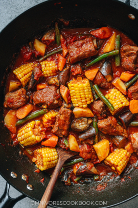 Chinese pork and vegetable stew in a wok close up