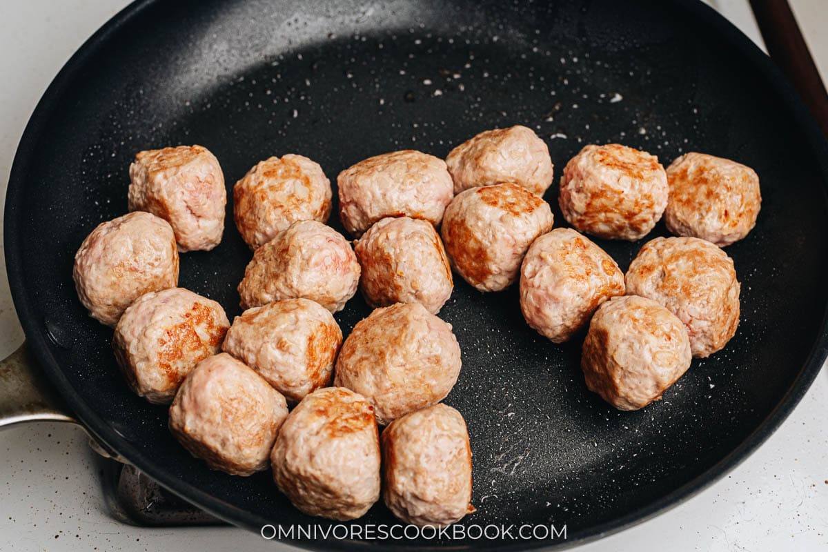 Brown Asian turkey meatballs in a pan