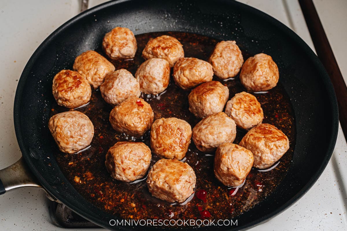 Adding sauce to Asian turkey meatballs