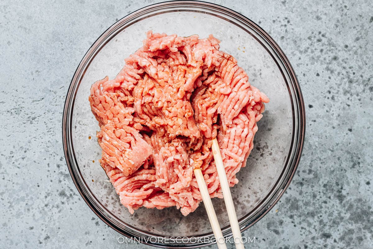 Mixing ground meat in a bowl