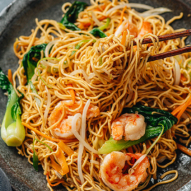 Shrimp chow mein pulled with chopsticks