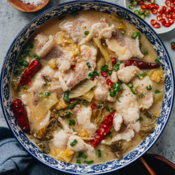 Suan Cai Yu is a classic Sichuan dish that features tender flavorful fish slices in a rich hot and sour broth made with Chinese pickled vegetables. This recipe shares how to recreate the authentic restaurant flavor at home using a simplified method.