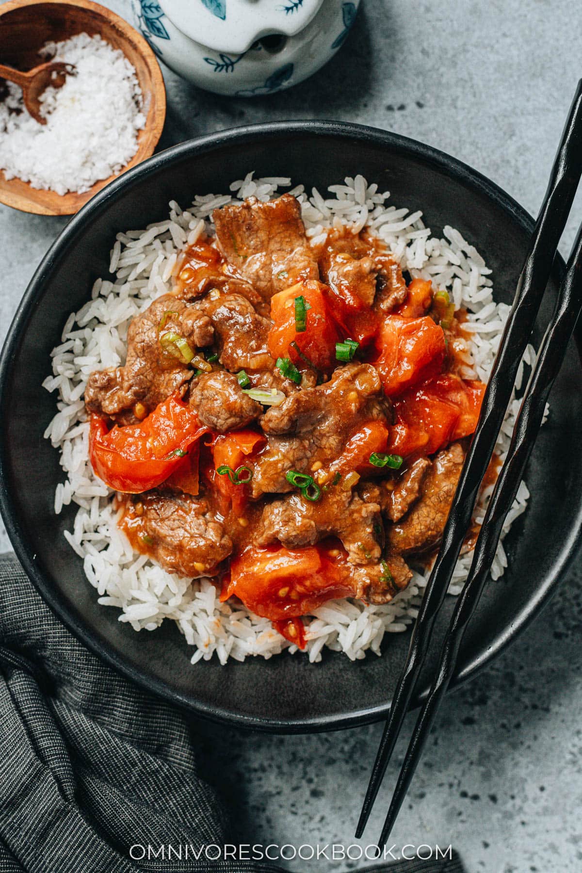 Beef and tomato stir fry topped over steamed rice