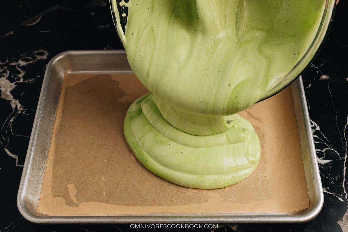 Pouring the cake batter onto a baking sheet