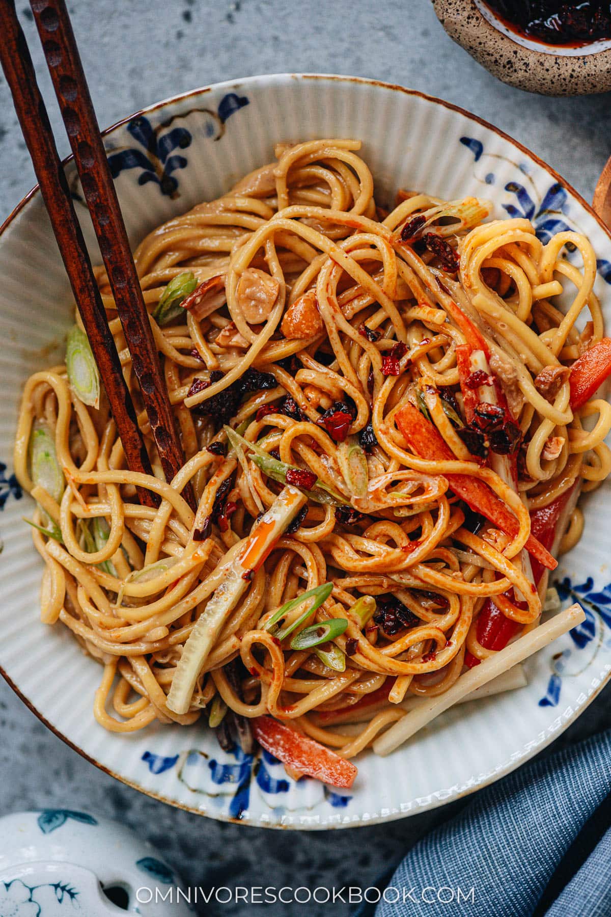 Mixing peanut noodles with chili crisp