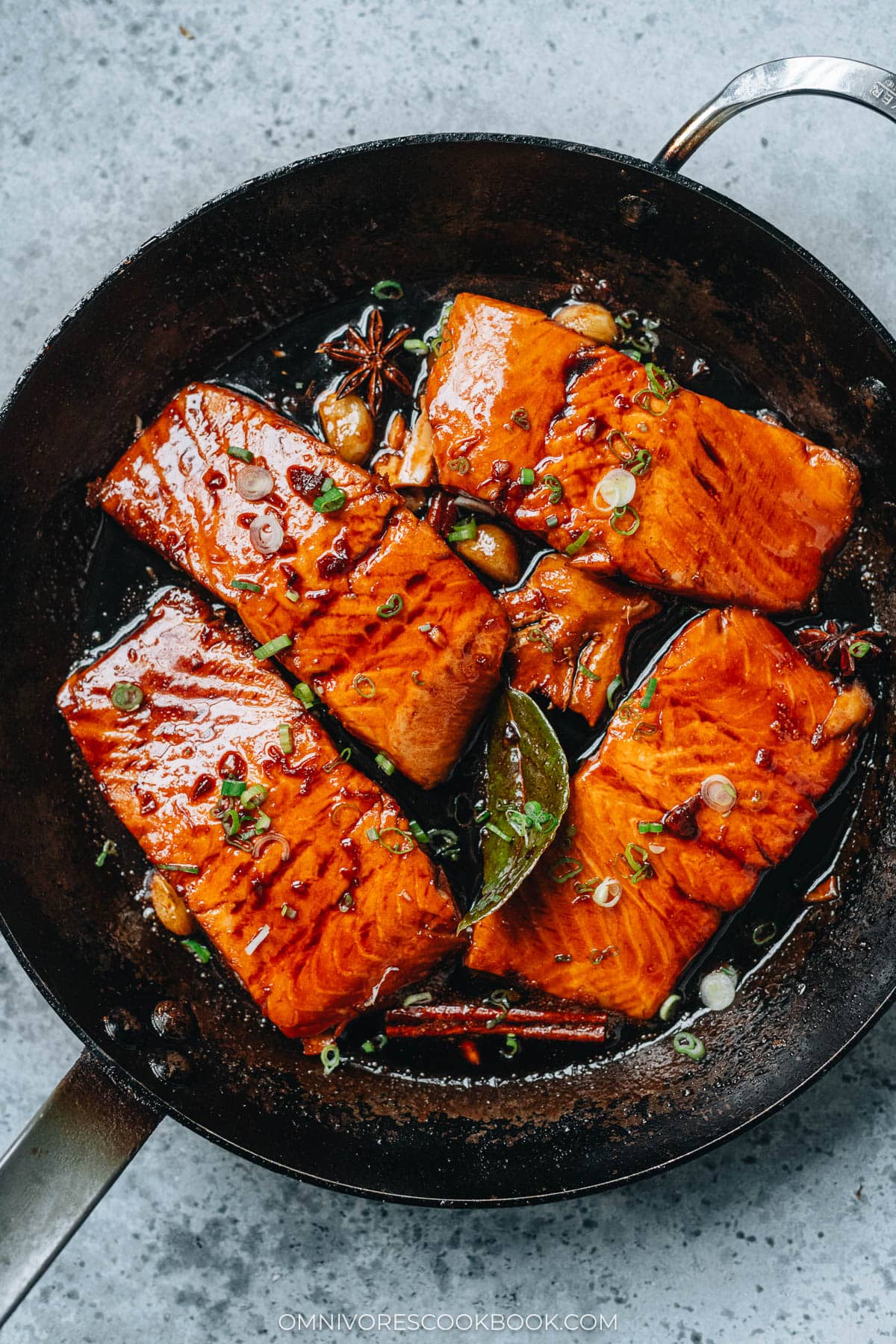 Four pieces of honey glazed salmon in a pan