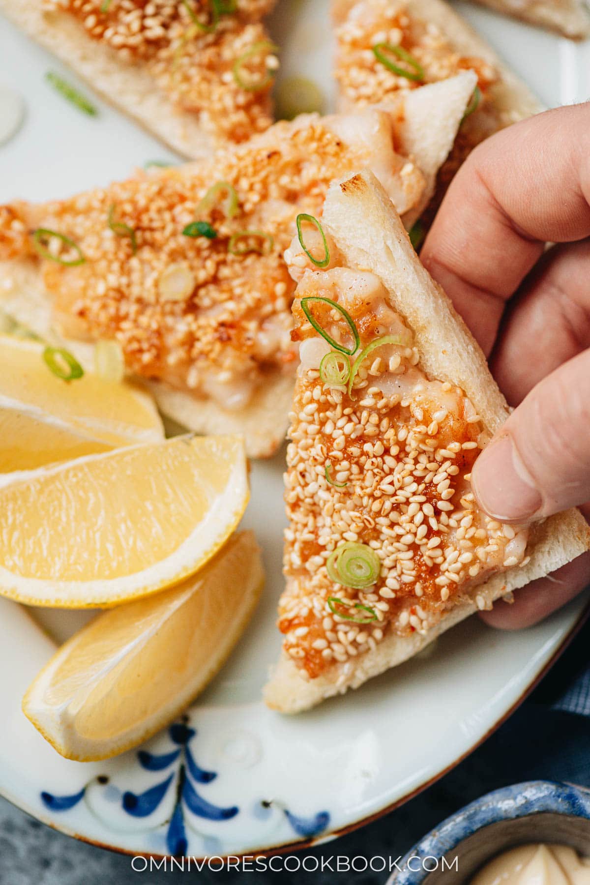 Holding a piece of shrimp toast