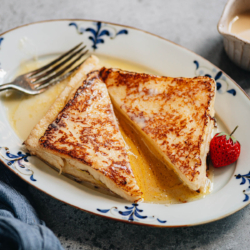 A decadent Hong Kong French toast made with a runny custard filling, pan fried until golden, then served with condensed milk and butter. Make this one for your Sunday brunch or as a delicious treat for a special occasion.