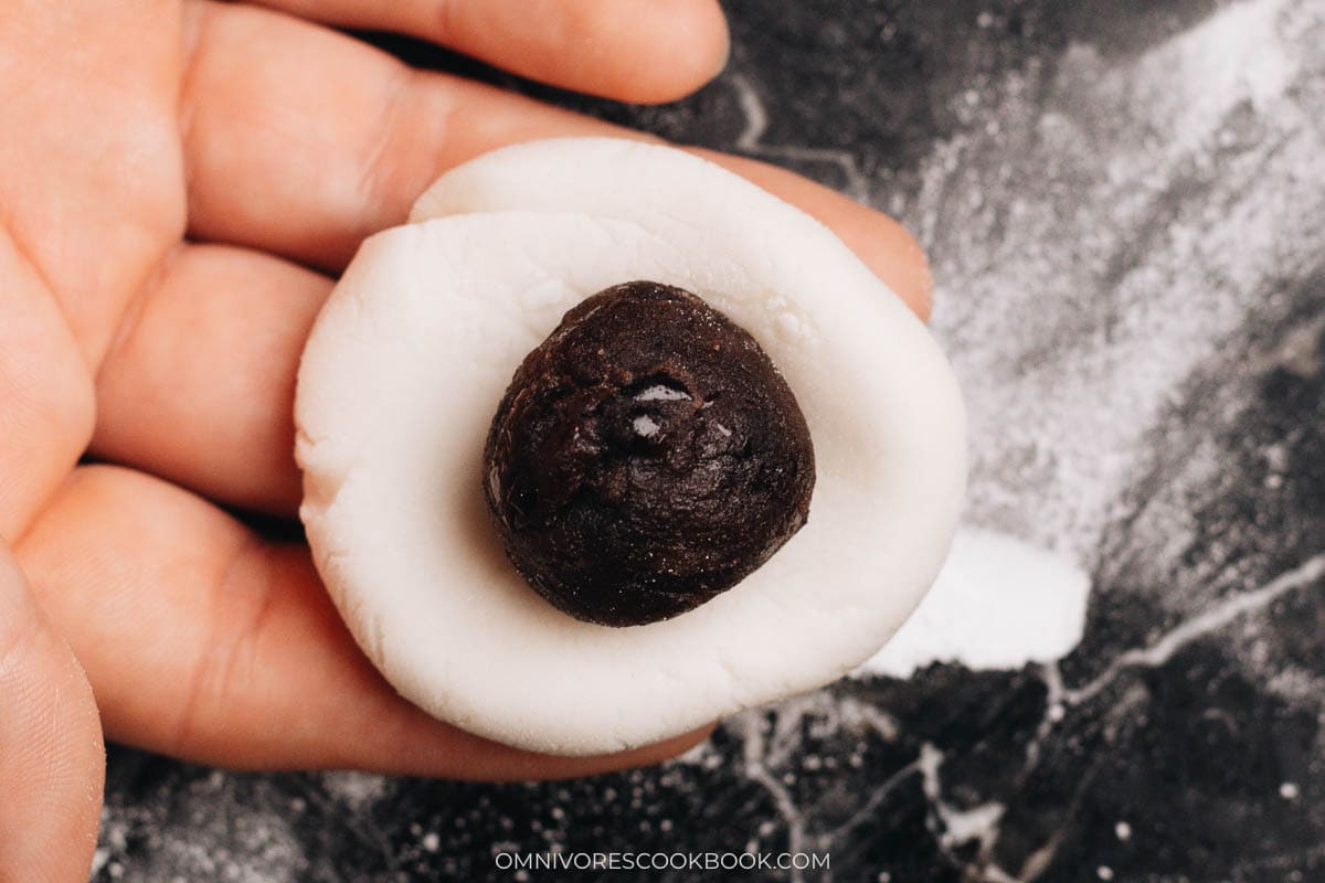 Adding the red bean paste onto the wrapper