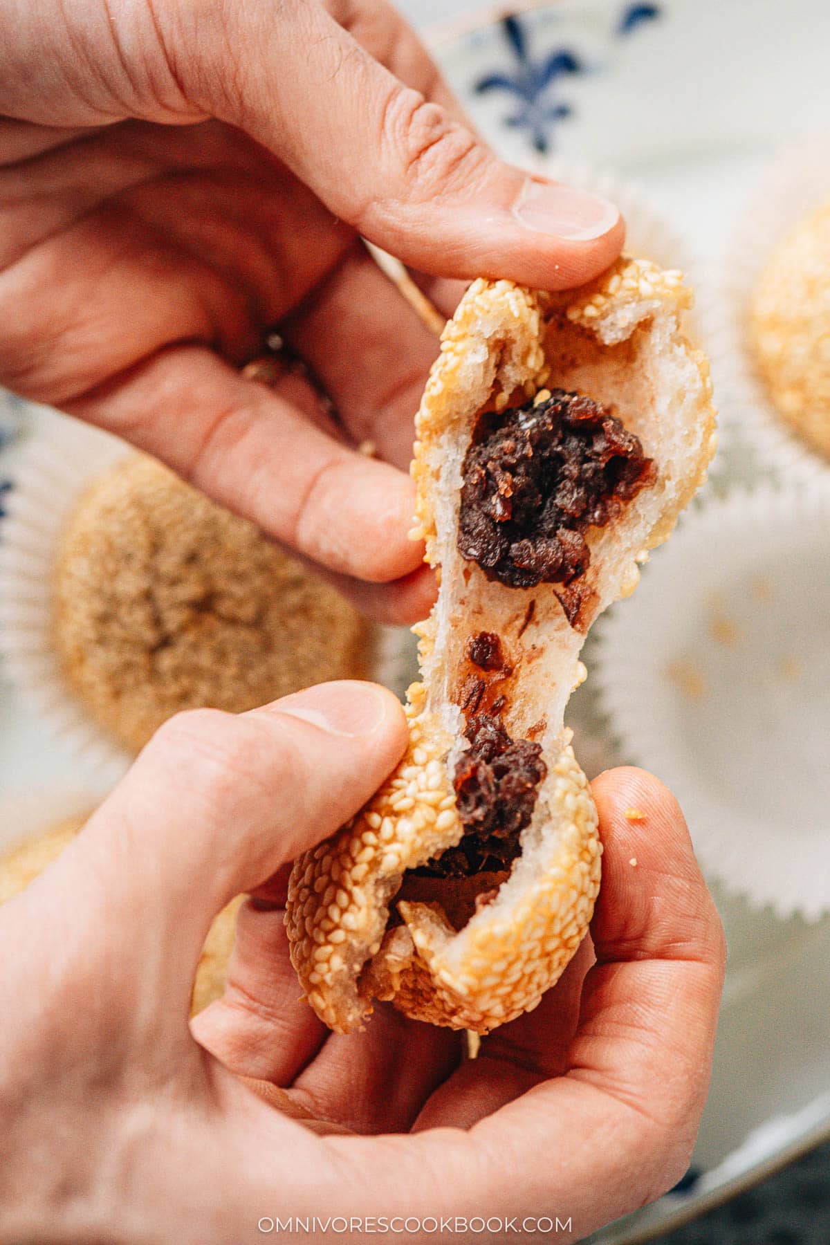 Tearing open a sesame ball with red bean paste filling