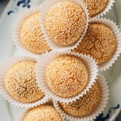 Make these crispy sesame balls that’re golden crispy on the outside and chewy on the inside, with a sweet red bean paste for your dim sum party or Chinese New Year feast. {Vegetarian, Gluten-Free}