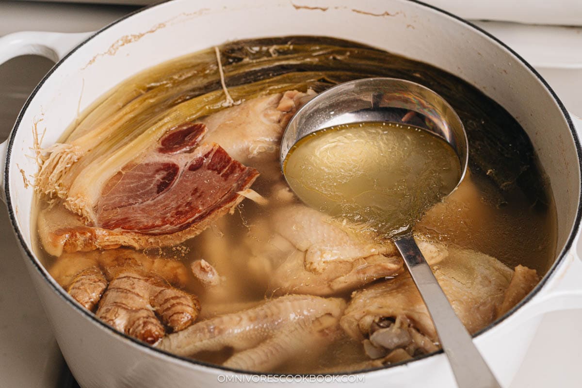 Skimming foam from the top of the soup