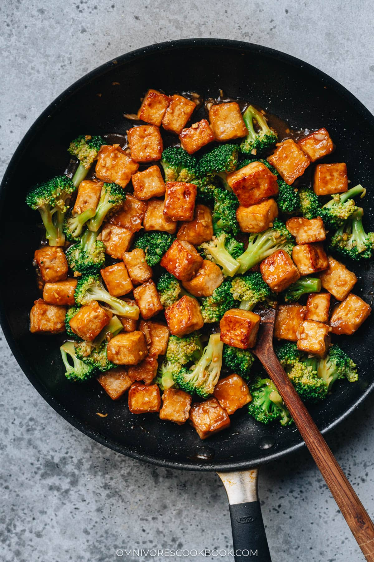 Tofu with broccoli in brown sauce in frying pan