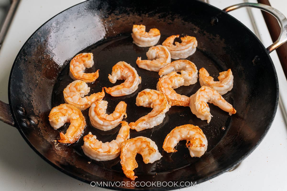 Searing shrimp in a pan