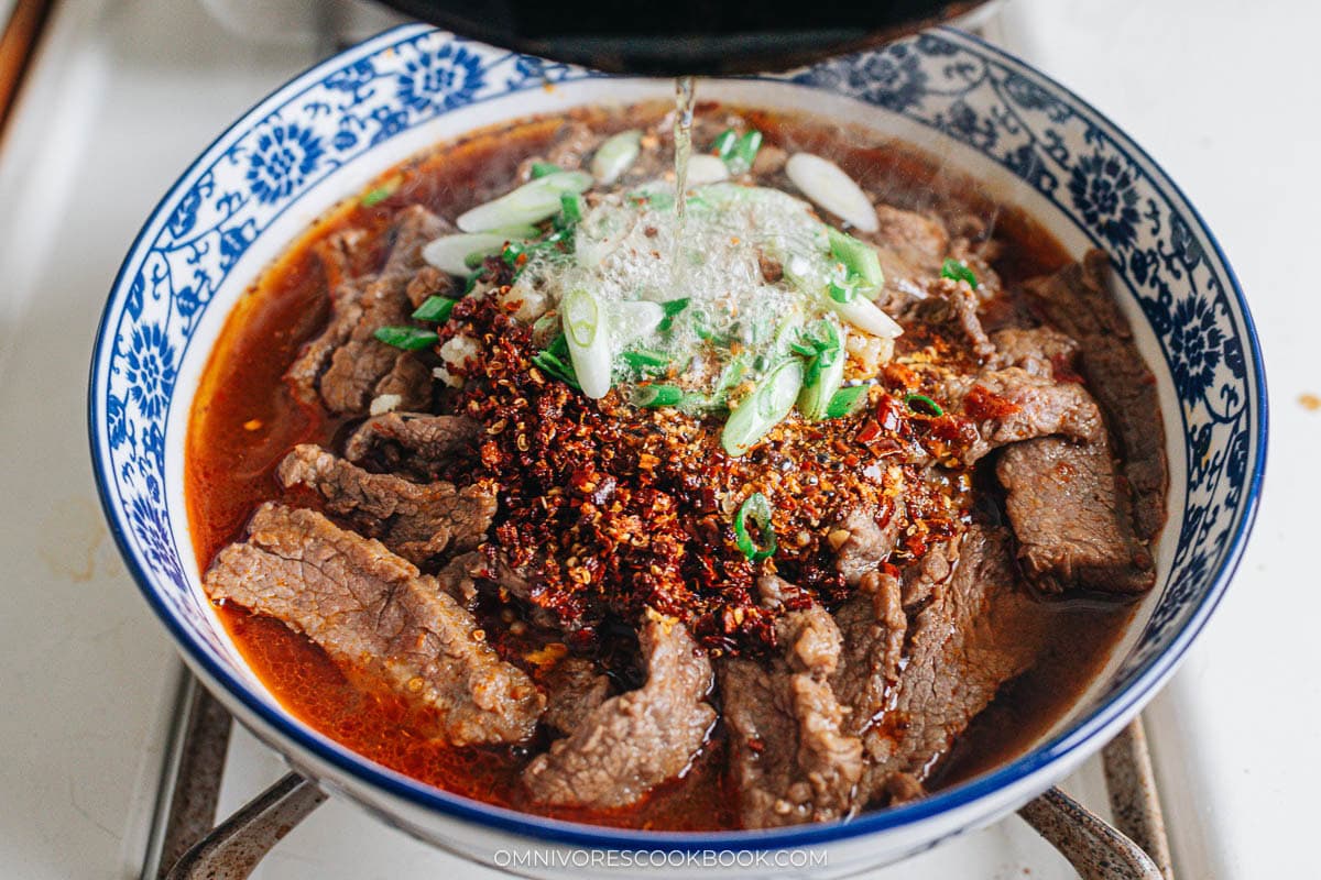 Finish up Sichuan boiled beef by drizzling hot oil