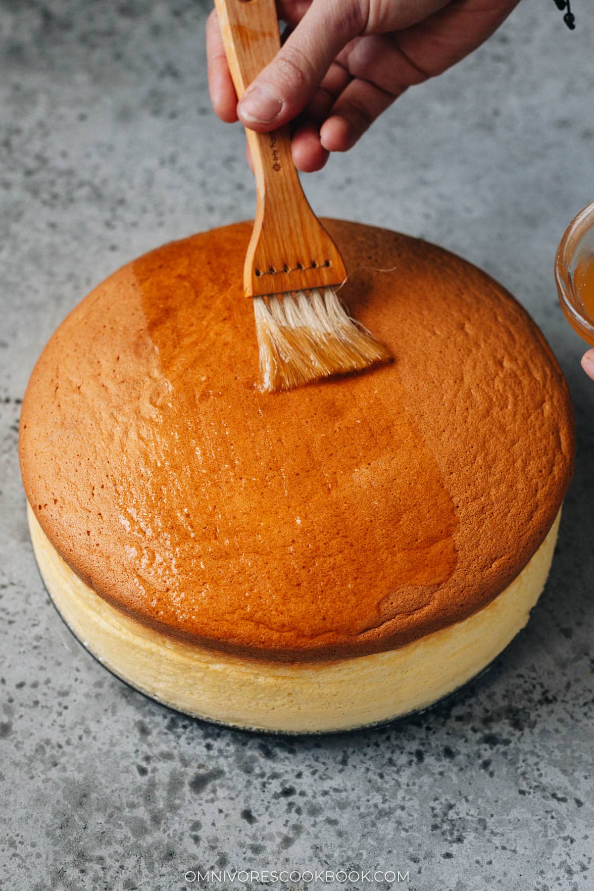 Brushing apricot glaze onto Japanese cheesecake