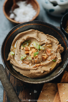 Chicken liver pâté served in a bowl with shallot, scallion and olive oil