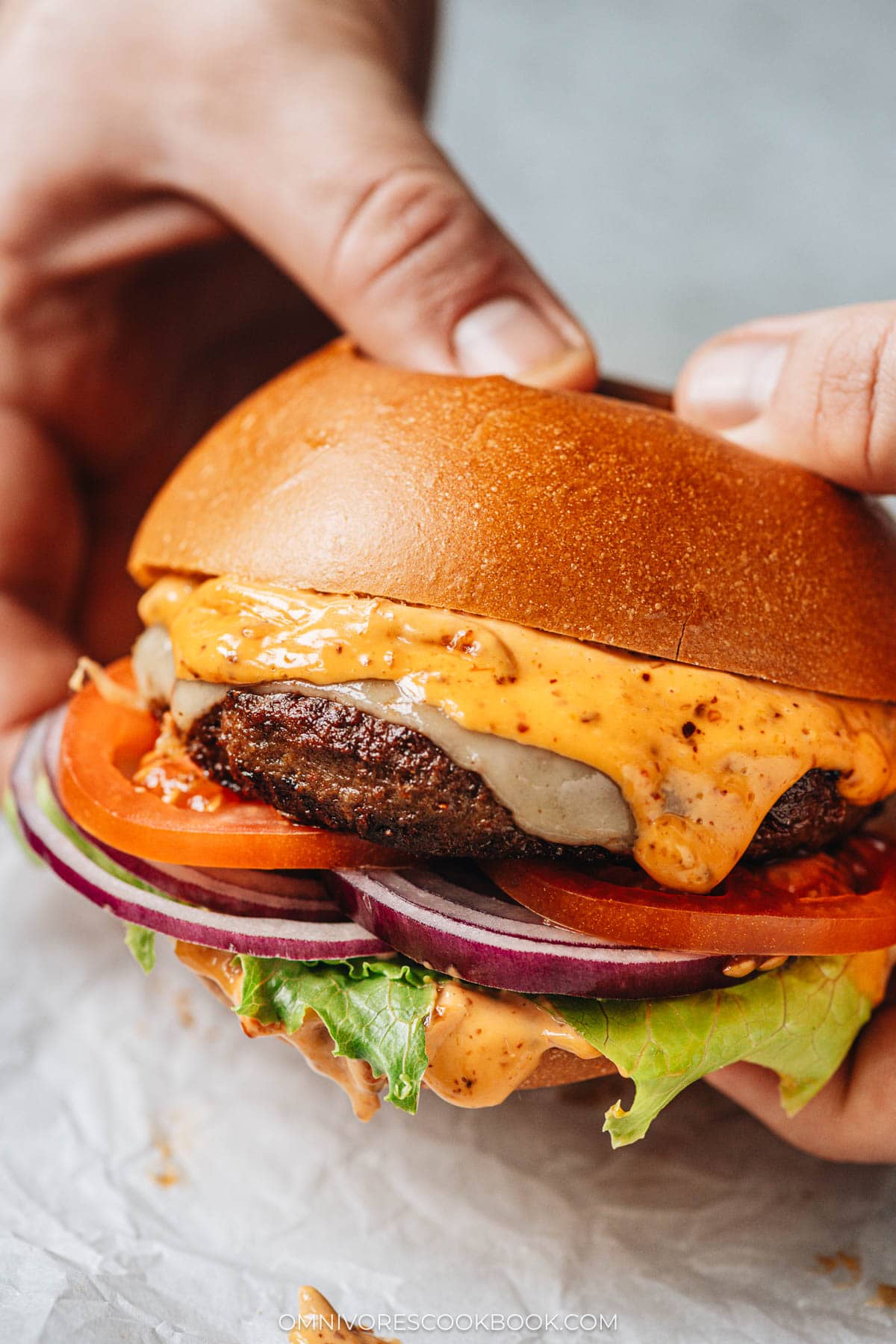 Holding a lamb burger with hands