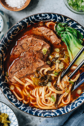 Taiwanese beef noodle soup with bok choy and mustard greens