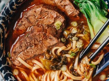 Taiwanese beef noodle soup with bok choy and mustard greens