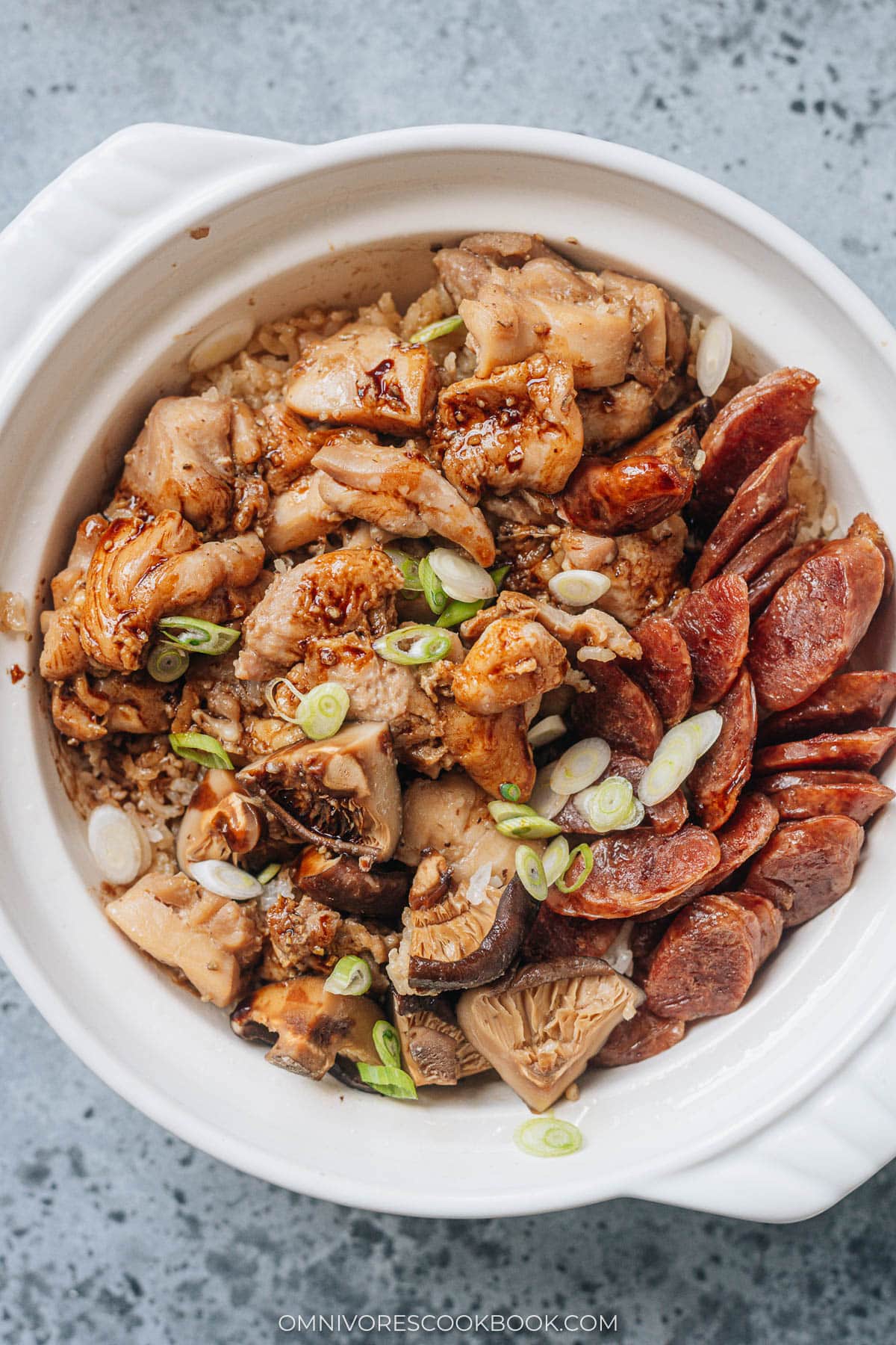 Drizzle seasoned sweet soy sauce over cooked claypot rice
