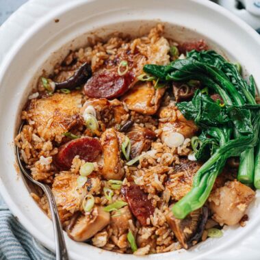 Homemade claypot rice with chicken, sausage, mushrooms and gai lan