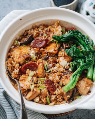 Homemade claypot rice with chicken, sausage, mushrooms and gai lan