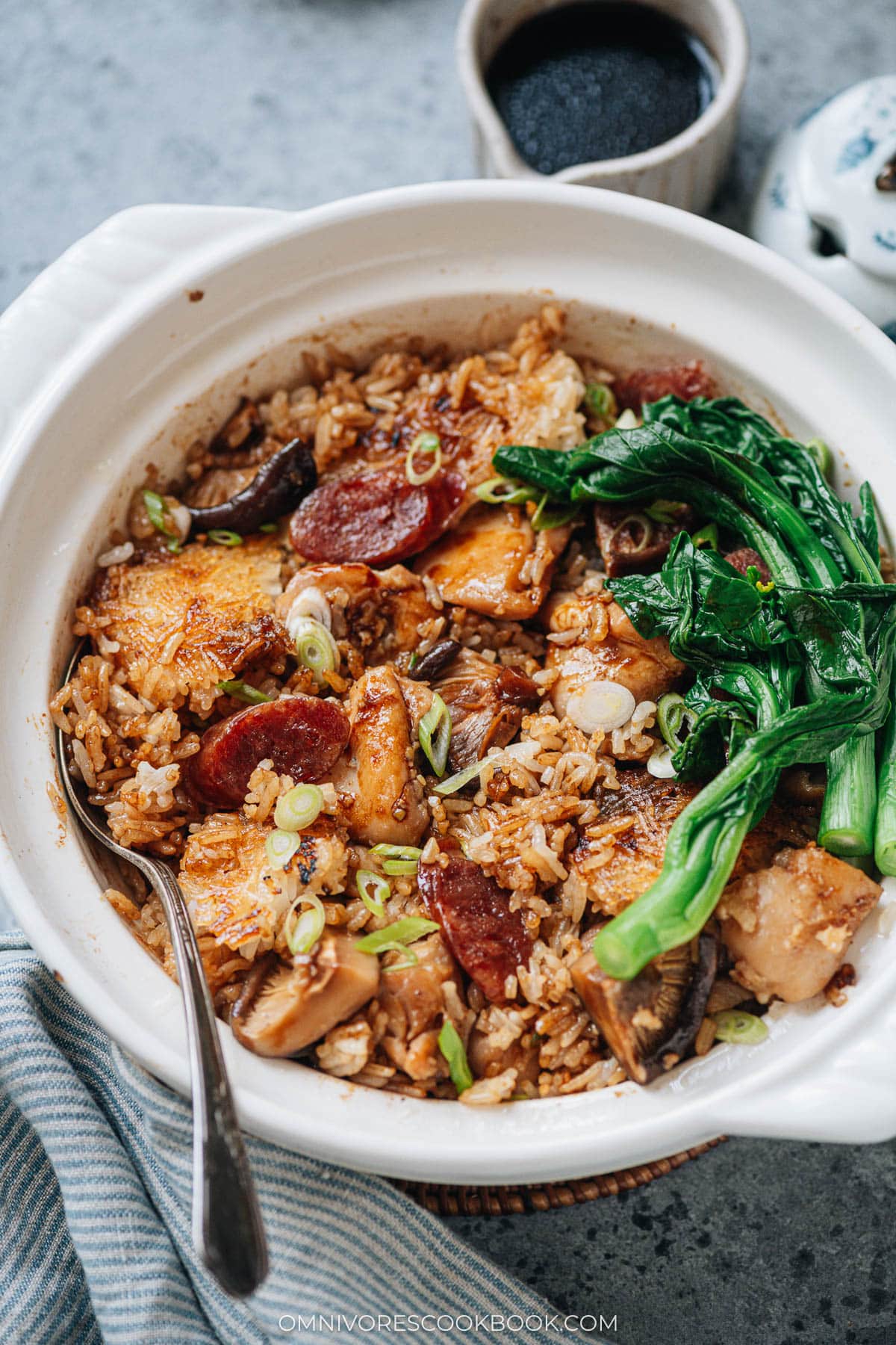 Homemade claypot rice with chicken, sausage, mushrooms and gai lan