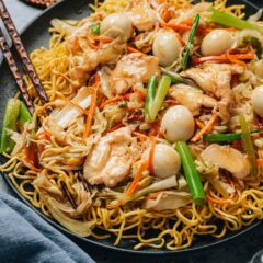 Chicken pan fried noodles feature crispy egg noodles topped with tender chicken and colorful vegetables cooked in a chicken stock based sauce.