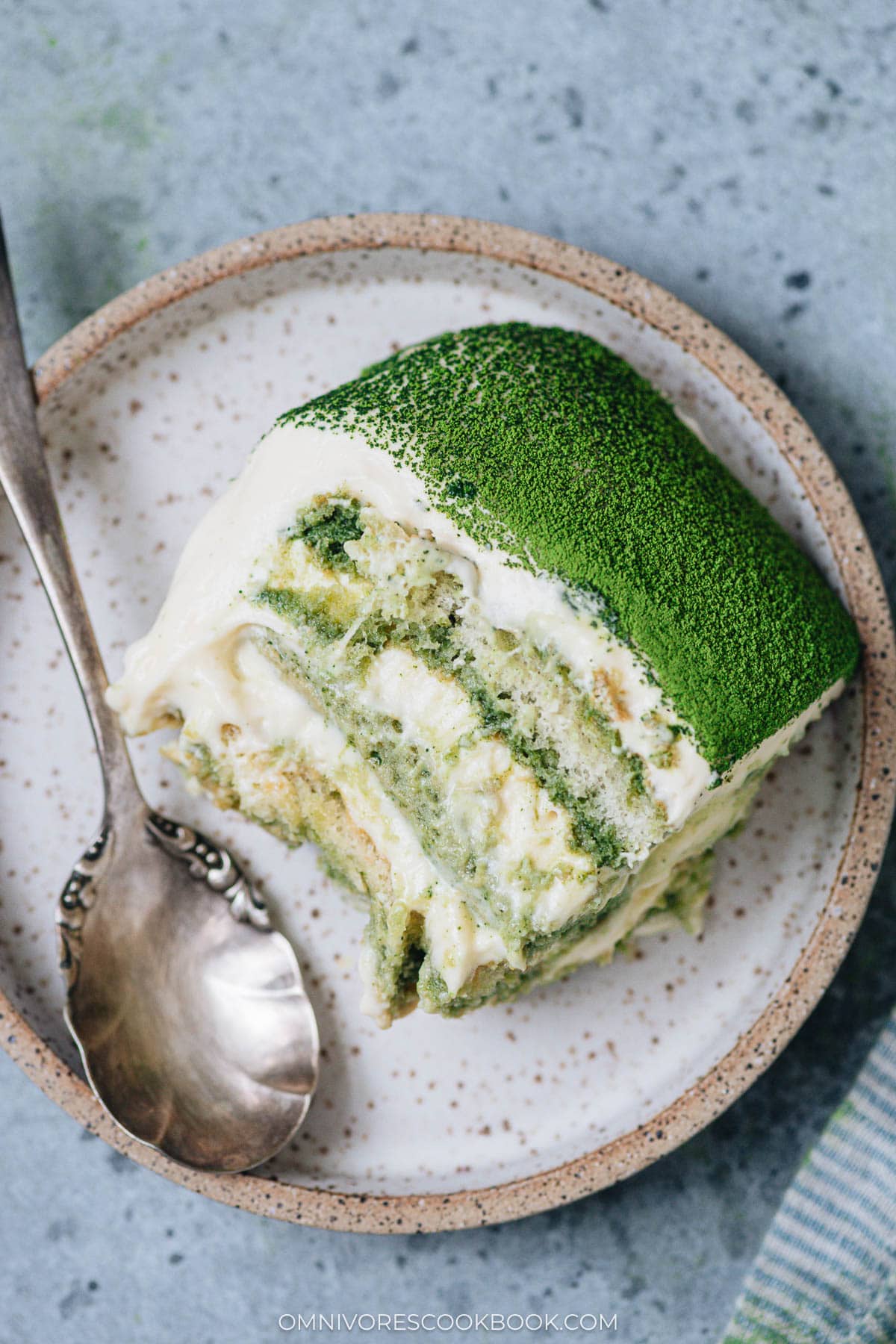 Serving matcha tiramisu on a plate