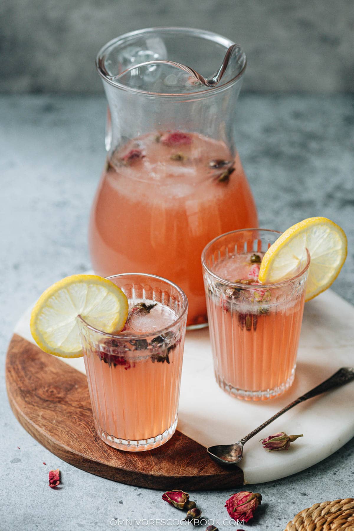 Glasses of rose lemonade garnished with sliced lemons