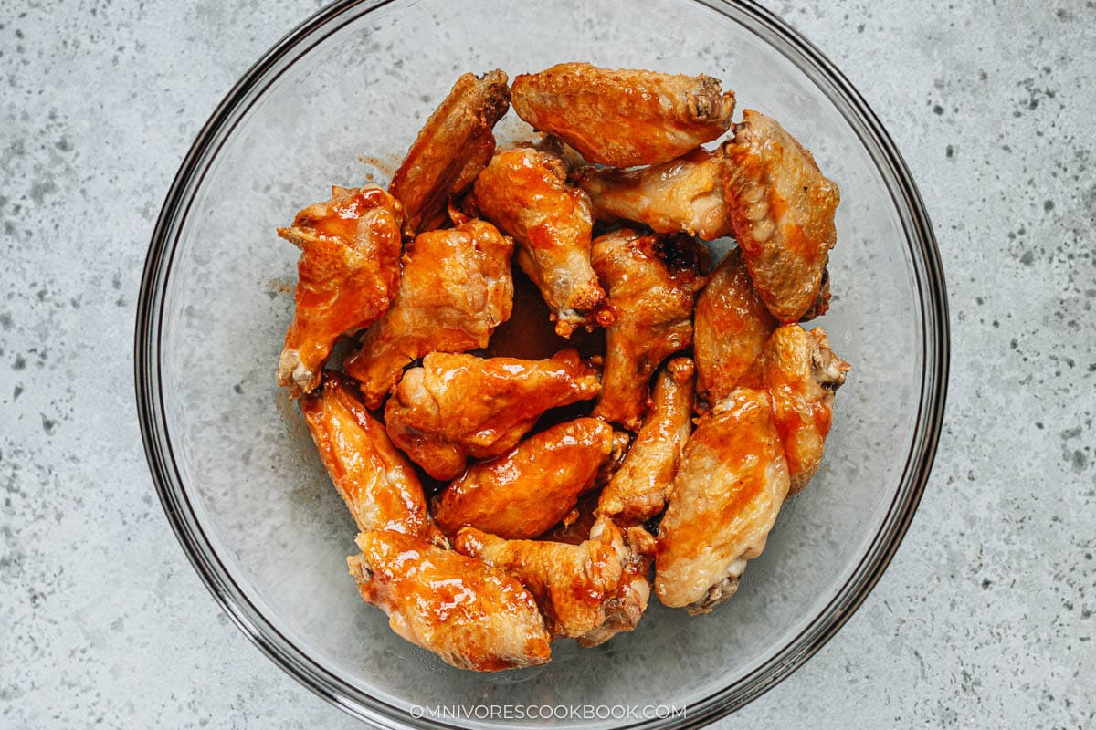 Tossing the wings with sauce