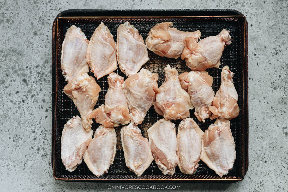 Uncooked wings on an air fryer tray
