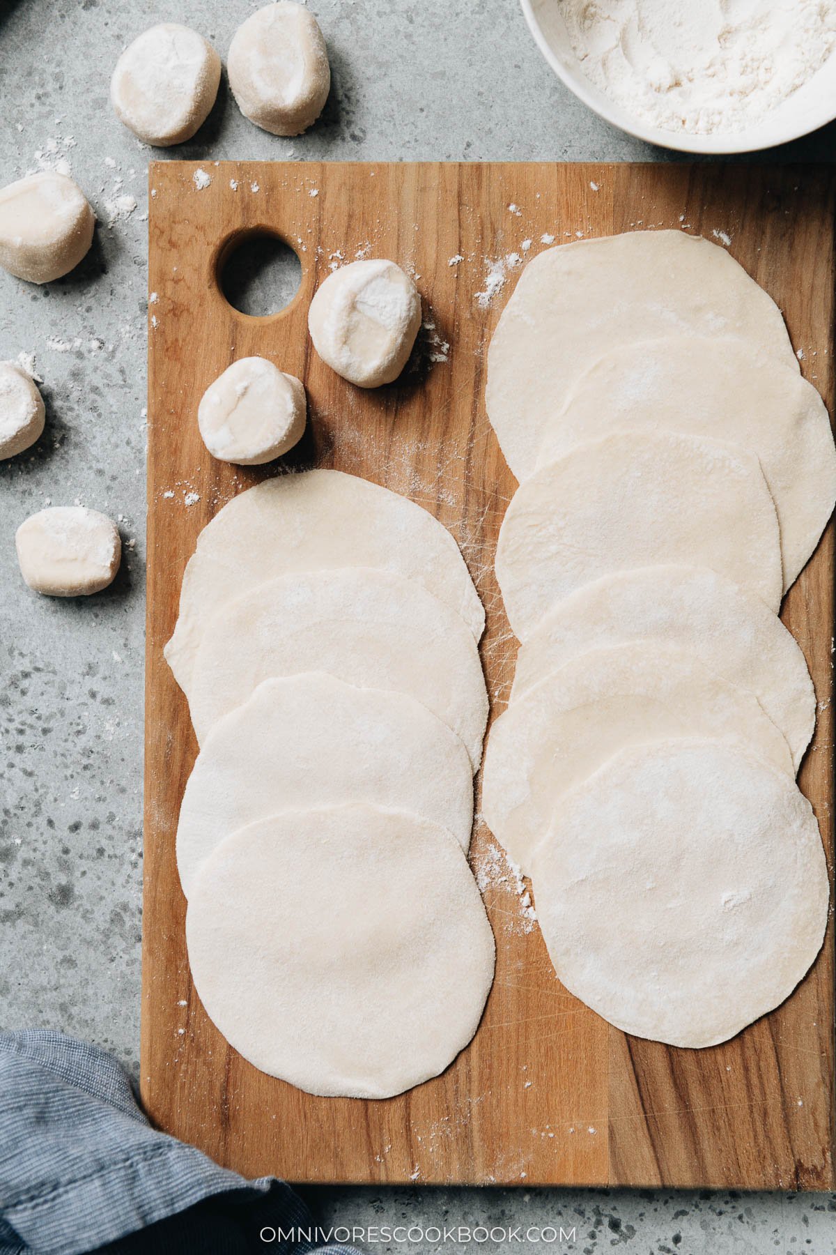 Homemade dumpling wrappers on a cutting board