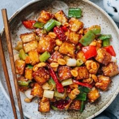Kung pao tofu is a bold tasting stir-fry that captures everything people love about Sichuan cuisine. Golden crispy tofu cubes soak up the rich sauce that’s savory, sweet and tangy, spiced up with chili pepper and Sichuan peppercorn. Crunchy peanuts, sweet scallion, and crisp pepper add color and texture. It’s a dish that’s as comforting as it is exciting, perfect for anyone craving the punchy flavors of classic Chinese cooking