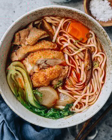 Chinese spicy chicken noodle soup with bok choy served in a bowl