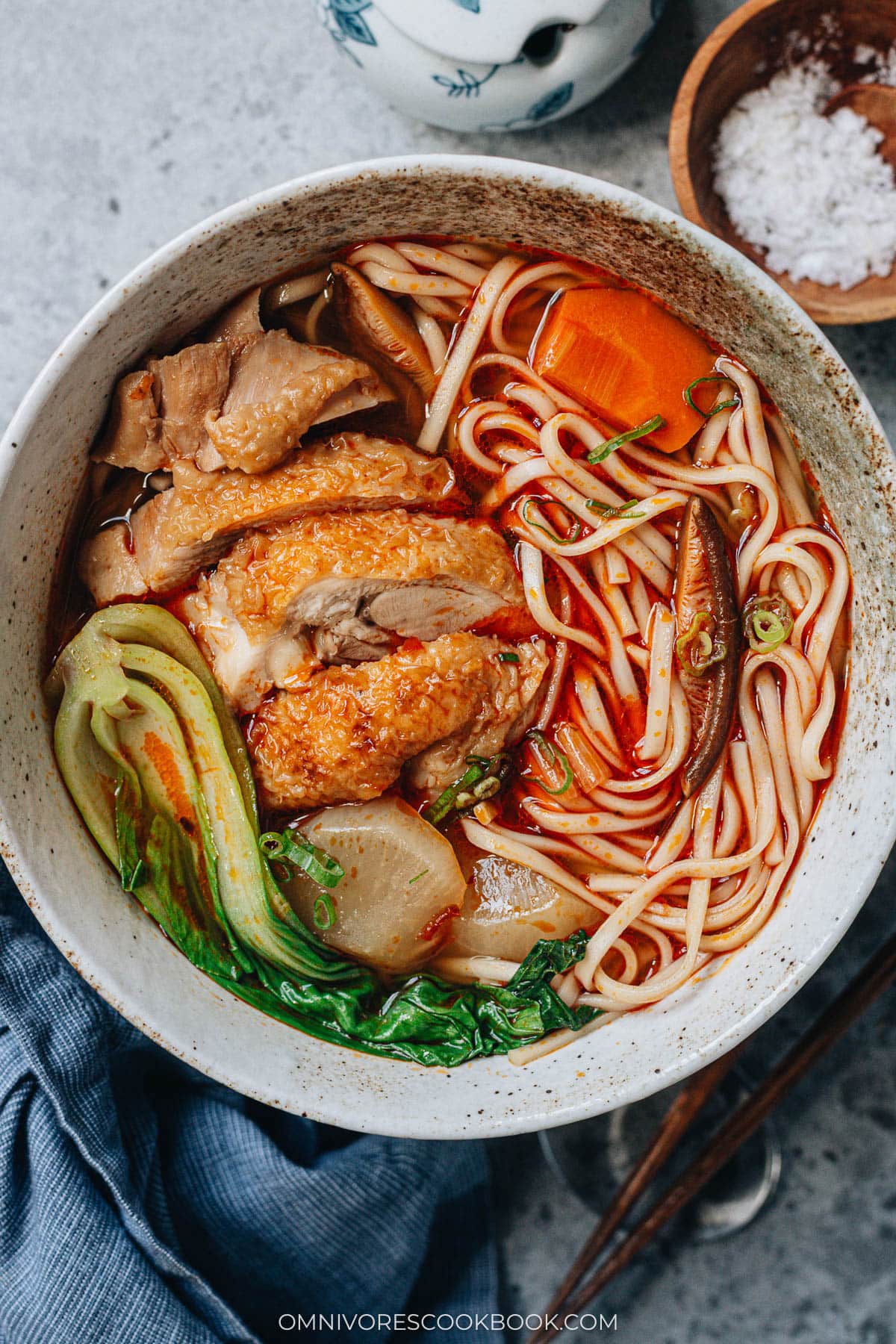 Chinese spicy chicken noodle soup with bok choy served in a bowl