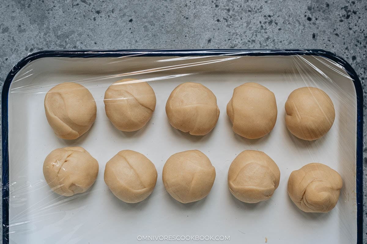 Shaped dough balls covered in a tray