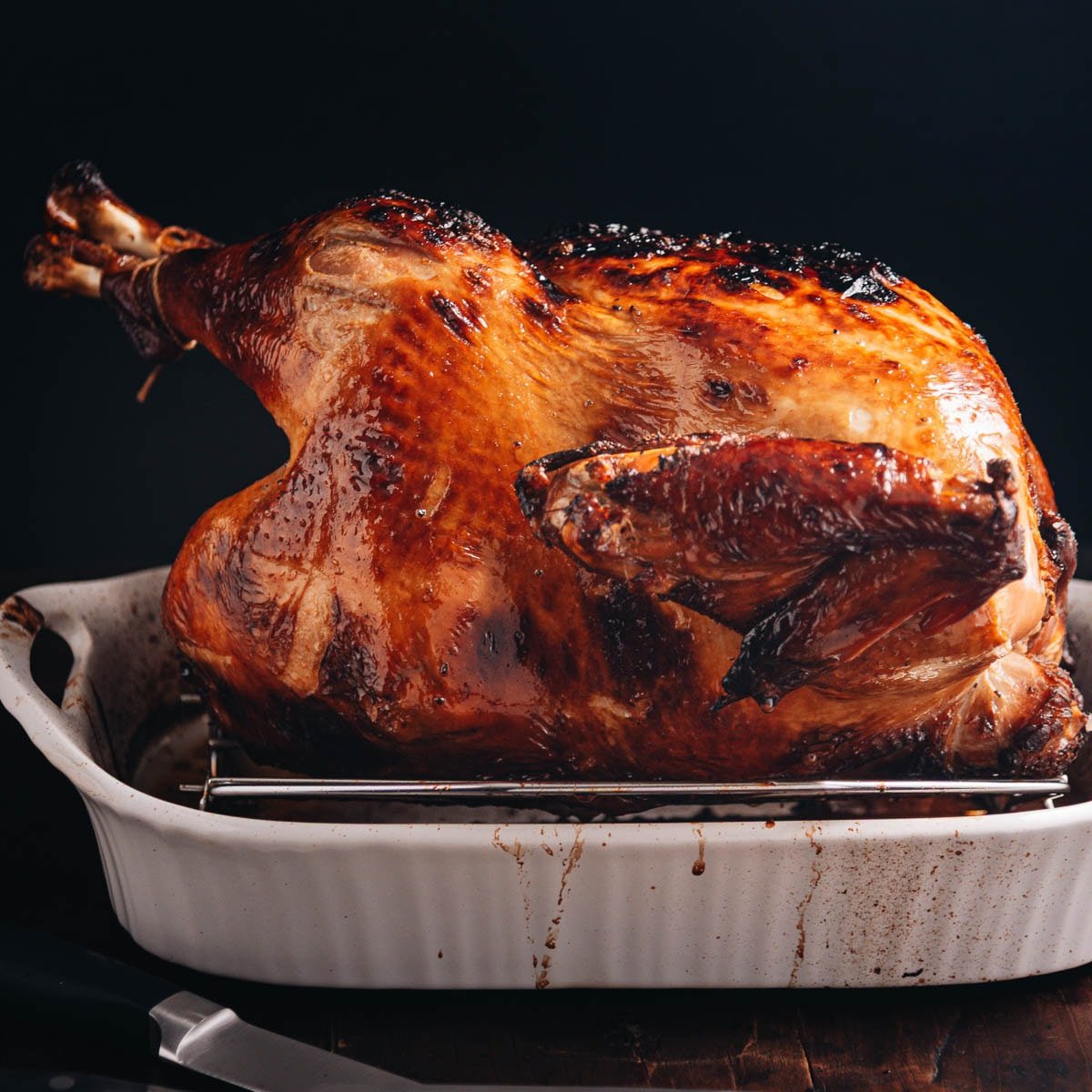 Chinese brined whole turkey in a baking dish ready to carve