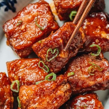 Using chopsticks to pick up a Peking pork rib