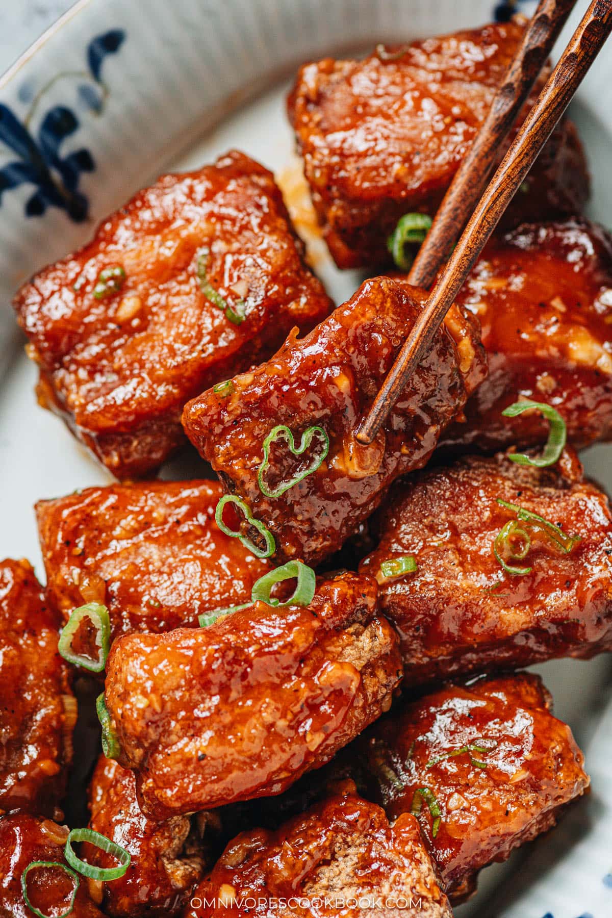 Using chopsticks to pick up a Peking pork rib